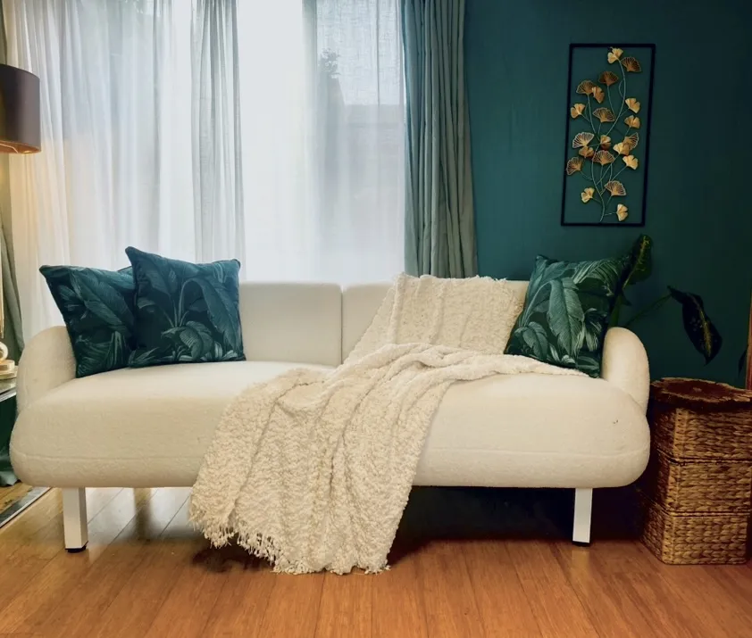 Jeuje Interiors boucle sofa with green cushions 